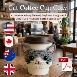 May include: A crocheted cat-themed coffee cup cozy in gray and white, with pink accents on the ears and nose. The cozy is wrapped around a disposable coffee cup with a brown lid. Text on the image reads "Cat Coffee Cup Cozy".