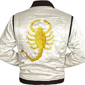 May include: White satin bomber jacket with a brown collar and cuffs. The back of the jacket features a large embroidered scorpion in gold.