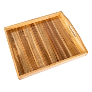May include: A rectangular wooden serving tray with a light brown frame and a striped interior. The interior is made of various shades of brown wood, arranged in vertical stripes. The tray has cut-out handles on each side.