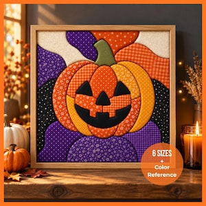May include: A square framed fabric wall art piece featuring a quilted pumpkin design with a green stem and black facial features. The pumpkin is composed of orange, yellow, and purple patterned fabric segments against a dark background.
