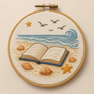 May include: Embroidered artwork in a wooden hoop depicts a beach scene with an open book, seashells, starfish, and seagulls. The ocean waves are rendered in blue thread, and the sand is beige. The book has tan pages and a blue cover.