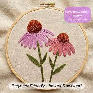 May include: Hand embroidery pattern featuring two coneflowers in a wooden hoop. The flowers have pink petals and brown centers, with green stems and leaves. The text "Hand Embroidery Pattern Step By Step Guide" and "Beginner Friendly Instant Download" are visible.
