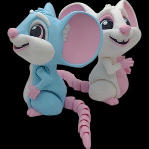 May include: Two cartoon mice figurines. One is light blue with pink ears, paws, and tail. The other is white with pink ears and paws. Both have smiling faces and are set against a black background.