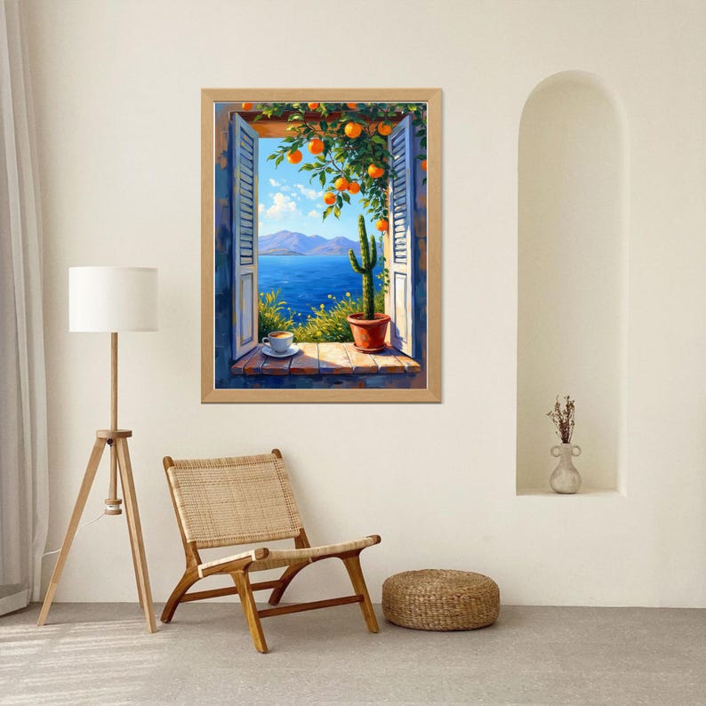 May include: A framed painting depicts a scenic view through a window. The window reveals a blue sea, mountains, and a blue sky with clouds. A cactus in a terracotta pot sits on the windowsill, with oranges hanging from a tree above.