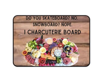 May include: A wooden board with a variety of food items, including cheese, crackers, fruit, and meat. The text on the board reads "Do you skateboard? No. Snowboard? Nope. I Charcuterie Board."