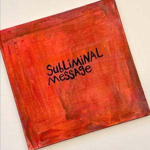 May include: A square canvas painting featuring a vibrant, textured background of blended red, orange, and deep crimson brushstrokes. Centered on the canvas, the words "SUBLIMINAL MESSAGE" are written in bold, black, hand-drawn capital letters.