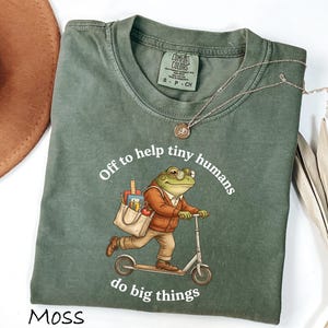 Comfort Colors® Off To Help Tiny Humans Do Big Things Shirt, Funny Frog Teacher Graphic Shirt, First Grade Teacher Shirt, Teacher Gift
