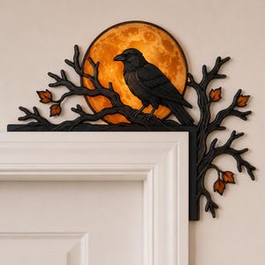 May include: A black raven perched on a dark, leafless branch structure that frames a circular, glowing orange moon. This decorative door corner accent features small, orange-tinted leaves attached to the branches, creating a detailed silhouette.