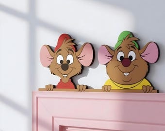 May include: Two cartoon mouse wall decorations featuring brown fur, large pink ears, and smiling faces. The left mouse wears a red hat and shirt, while the right mouse wears a green hat and yellow shirt. Both figures are positioned side by side.