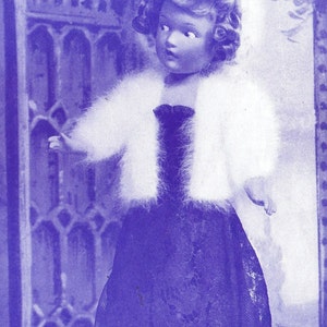 May include: A doll wearing a white fur coat and a black lace dress. The doll has blonde hair and blue eyes.
