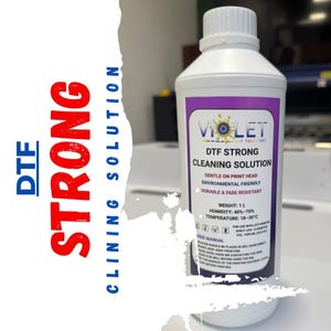 May include: A white bottle of DTF Strong Cleaning Solution with a purple label. The label includes the brand name "Violet" and product details. The bottle contains 1 litre of cleaning solution and is designed for use with DTF printers.