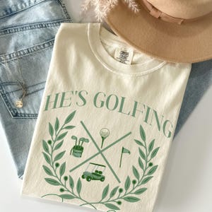 He&#39;s Golfing Social Club Tee, Golf Wives Social Club Shirt,  Golf Wife Shirt, Funny Wife Gift, Comfort Colors Tee for Wives of Golfers