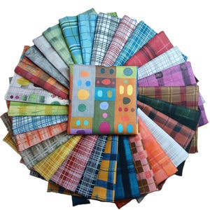 May include: A collection of colorful fabric squares arranged in a circular pattern. The fabrics display various patterns, including plaid, stripes, and abstract designs. The central square features a geometric pattern with circles and rectangles in multiple colors.