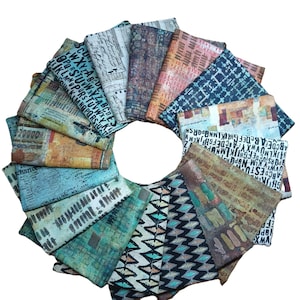 May include: A circular arrangement of folded fabric squares with various patterns and colors. The fabrics display designs including letters, geometric shapes, and abstract art in shades of blue, brown, orange, and green. The overall aesthetic is artistic and textured.