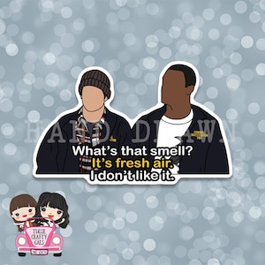 May include: A sticker featuring two cartoon characters, one wearing a beanie and the other a jacket with "Criminal Investigation Unit" on the back. The text "What's that smell? It's fresh air. I don't like it." is written below the characters.