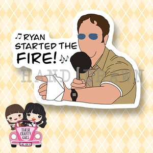 May include: A sticker featuring a cartoon illustration of a man with a microphone and a bandage on his arm. The text "Ryan Started the Fire!" is written above the man. The sticker is on a yellow and white checkered background.