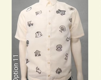 May include: Cream-colored short-sleeved button-down shirt with black embroidered designs. The shirt features various motifs, including a flag, tree, and fish. The text "Option 11" is on the left side of the image.