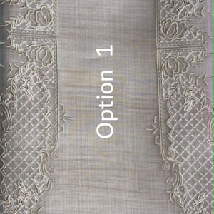 May include: A light beige fabric runner featuring intricate cream-colored floral embroidery along both vertical edges with a diamond-patterned mesh border. The center of the fabric displays a subtle horizontal weave texture. The text Option 1 is visible.