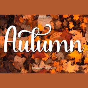 May include: A fall-themed graphic with the word "Autumn" in a white, handwritten font. The background features a collection of colorful autumn leaves in shades of orange, yellow, and brown. The text "Introducing Handwritten Font" is also included.