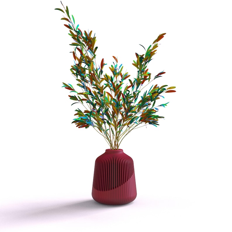 May include: A red vase with a ribbed design holds a bouquet of green, blue, and yellow leaves.