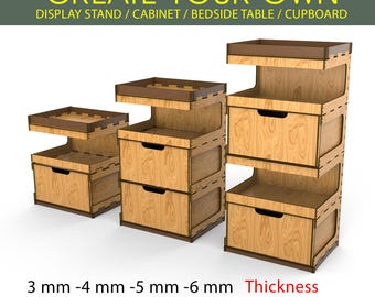 May include: Three wooden display stands, cabinets, or bedside tables with drawers and shelves. The stands are made of light brown wood with dark brown accents. The text at the top says "CREATE YOUR OWN" and the text at the bottom says "Thickness".