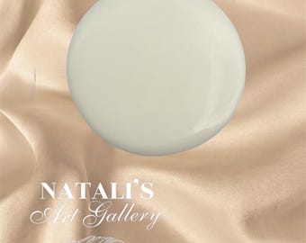 May include: A smooth, off-white, spherical object, possibly a decorative element or art piece, is centered against a backdrop of draped, satin-like fabric. The text "NATALI'S Art Gallery" is displayed in elegant script.