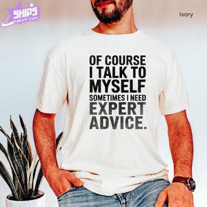 a man wearing a t - shirt that says of course i talk to mysel