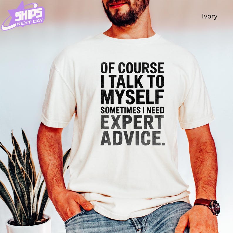 a man wearing a t - shirt that says of course i talk to mysel