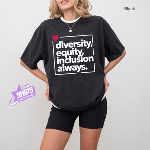 May include: Black t-shirt with a white graphic that says "diversity, equity, inclusion always." A red heart is in the upper left corner of the graphic.