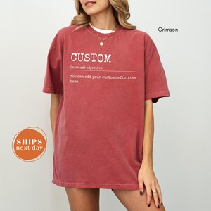 A woman wearing a red t-shirt with the word "CUSTOM" printed on it, along with the definition "custom adjective" and the phrase "You can add your custom definition here." The image also includes a shipping label and the word "Crimson" in the top right corner.