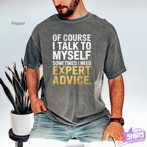 a man wearing a t - shirt that says of course i talk to my self