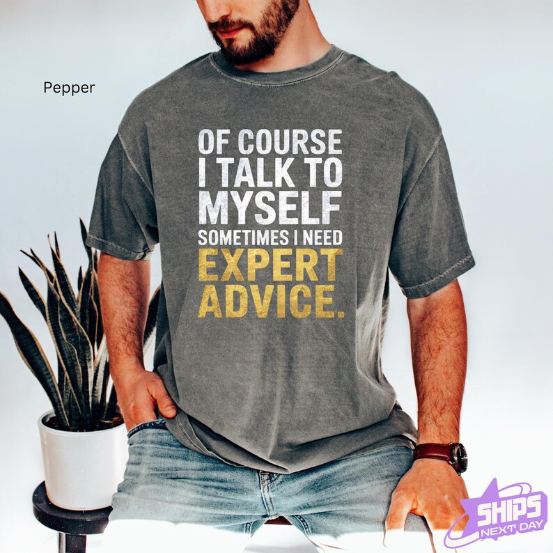 a man wearing a t - shirt that says of course i talk to my self