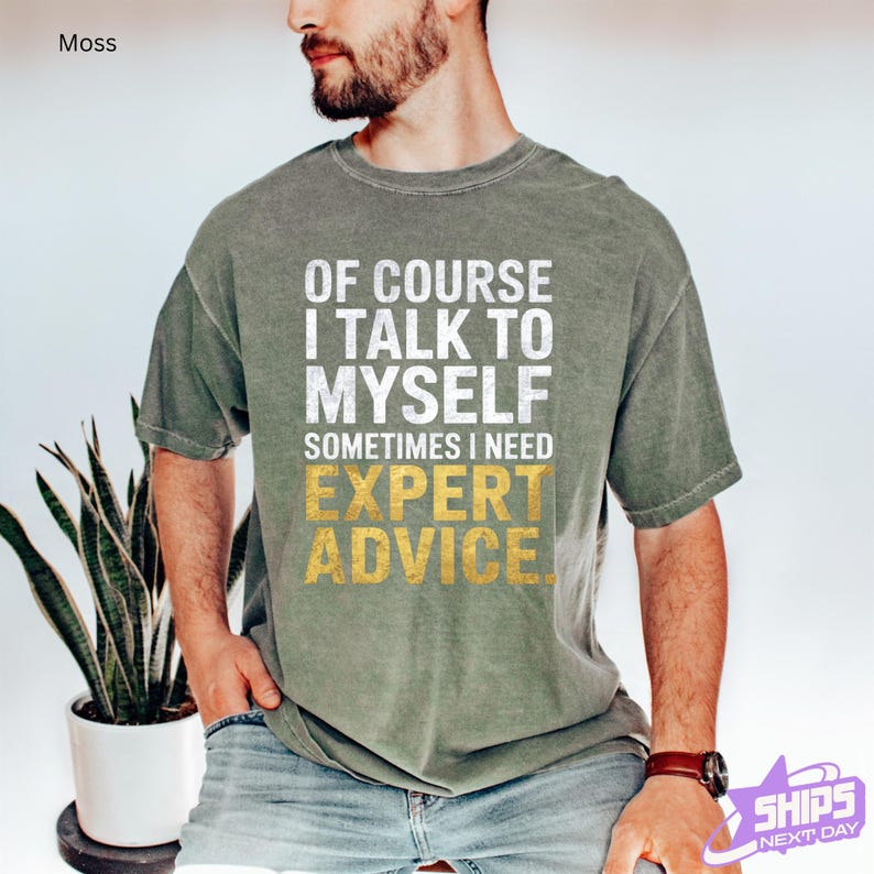 a man wearing a t - shirt that says of course i talk to mysel