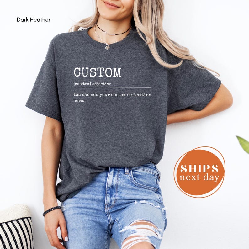A woman wearing a gray t-shirt with the word "CUSTOM" printed on it, standing against a white background.