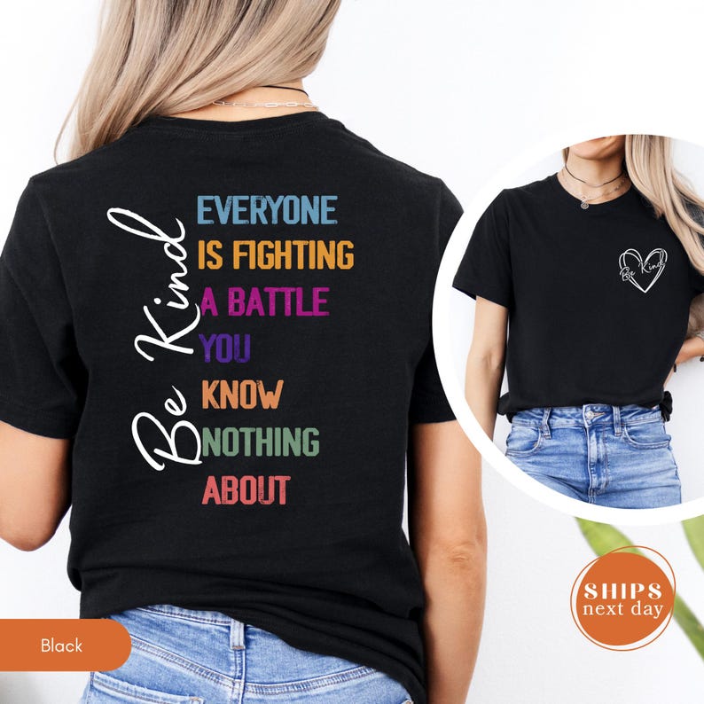 May include: Black t-shirt with the words "Be Kind" in a cursive font on the left side. The back of the shirt has the text "Everyone is fighting a battle you know nothing about" in various colors. A heart design is on the front.