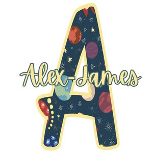 May include: A yellow outlined letter A with a blue background and a space-themed pattern. The letter A is filled with stars, planets, and rockets. The text "Alex-James" is written in yellow cursive script below the letter.