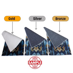 May include: Three rugs with a geometric pattern in blue, gold, and brown tones. The rugs are labeled "Gold", "Silver", and "Bronze". The underside of each rug is visible, with a white, dark blue, and gray pattern. The word "SAMPLE" is stamped on the image.