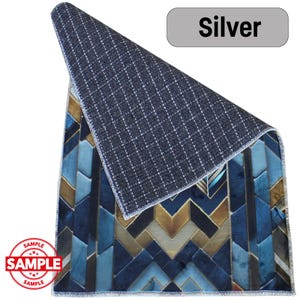 May include: A rectangular rug with a geometric pattern in shades of blue, gold, and teal. The rug's underside is a dark gray with a grid pattern. The word "Silver" is in a gray rectangle. The word "SAMPLE" is stamped on the rug.