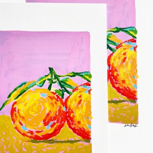 May include: Two bright orange fruits with green leaves on a pink background. The fruits are painted in a stylised way with yellow, orange, and red colours. The artist's signature is in the bottom right corner.