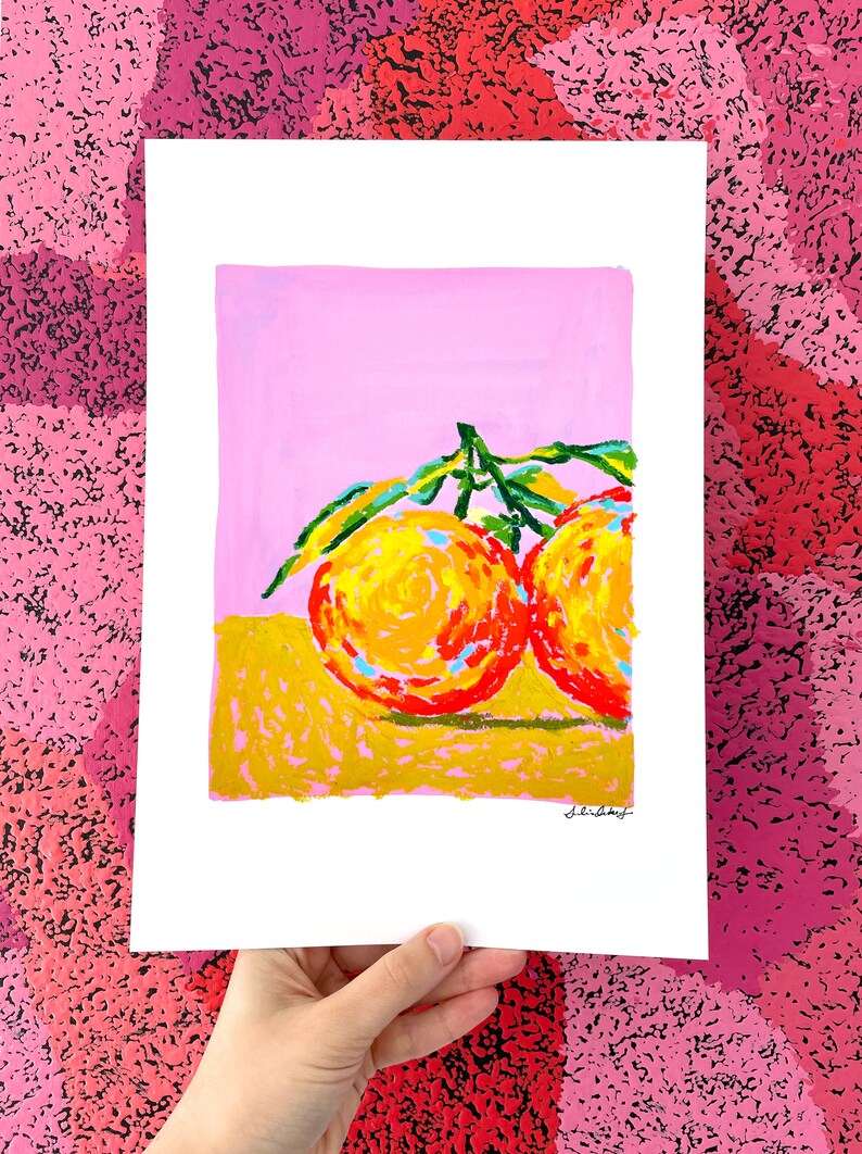 May include: A painting of two orange fruits with green leaves on a pink and yellow background.