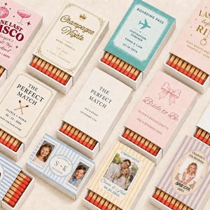 May include: A collection of rectangular matchboxes featuring various custom designs, including text, dates, names, and photographic portraits. Each box contains wooden matches with red tips, arranged in rows within the sliding cardboard sleeves.