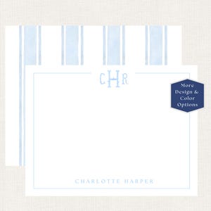 May include: A white stationery card featuring a light blue watercolor striped pattern on the back. The front displays a light blue monogram with the letters CHR at the top and the name CHARLOTTE HARPER at the bottom, framed by a thin border.