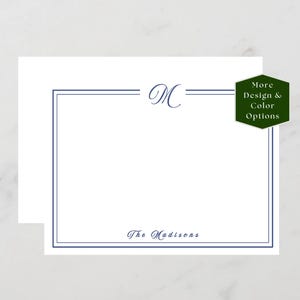 May include: White stationery with a navy blue border and the letter "M" in a script font. The text "The Madisons" is printed at the bottom. A green hexagon with the text "More Design & Color Options" is in the upper right corner.