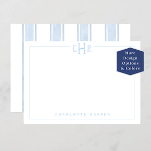 May include: White stationery with a light blue striped pattern at the top. The stationery features the initials "CHR" in light blue, with the name "Charlotte Harper" printed below. A navy blue hexagon with the text "More Design Options & Colors" is on the right.