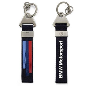 May include: Two silver keychains with black straps. One keychain has a blue, red, and white striped design and the other keychain has the text "BMW Motorsport" printed in white.