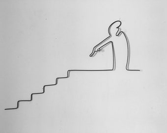 The line Osvaldo Cavandoli wire art, wall phrase, sculpture, staircase going up and down