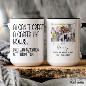May include: Two white ceramic mugs with black rims and handles. One mug has the text "AI CAN'T CREATE A CAREER LIKE YOURS. BUILT WITH DEDICATION NOT AUTOMATION." The other mug has a photo and the text "Happy Retirement Henry."