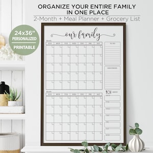 May include: A framed 24x36 inch printable family planner with a dark brown frame. The planner includes a 2-month calendar, a grocery list, and a meal planner. The text "Organize Your Entire Family In One Place" is at the top.