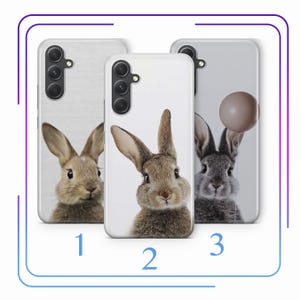 May include: Three phone cases with different images of rabbits. The first case has a brown rabbit with white fur around its ears. The second case has a brown rabbit with white fur around its ears. The third case has a gray rabbit with a balloon.