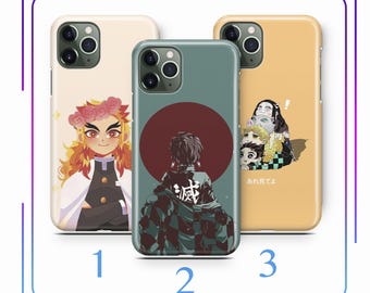 May include: Three different phone cases featuring characters from the anime Demon Slayer. The first case features a red-haired character with a flower crown. The second case features a character with black hair and a checkered pattern. The third case features three characters with a yellow background and the text "あけまして" in Japanese.